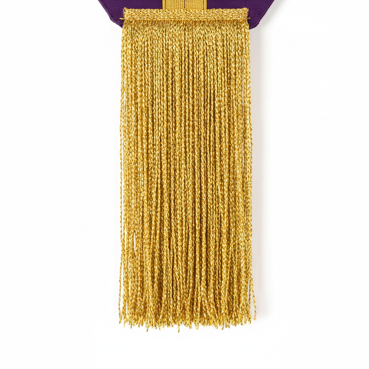 Close-up detail of the clergy stole bottom hem showing metallic gold fringe tassels, macro shot, white background
