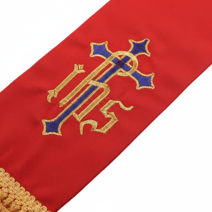 Close-up detail of red clergy stole showing IHS cross embroidery and gold fringe tassel, white background