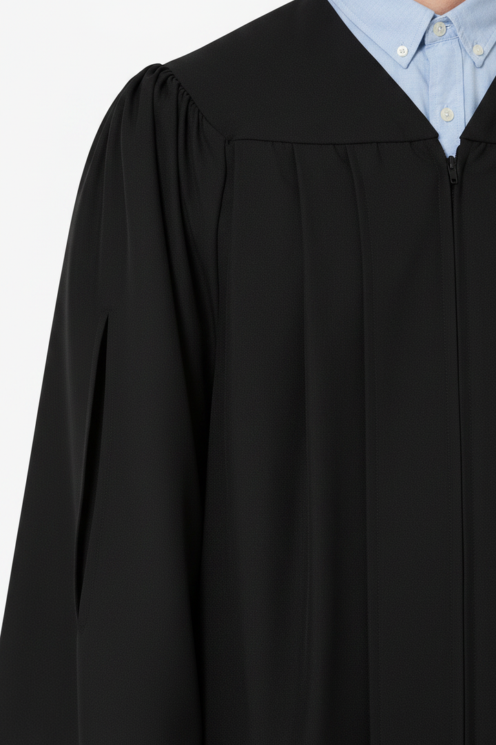 Close-up detail of economy master gown showing Tudor closed sleeve and matte polyester fabric