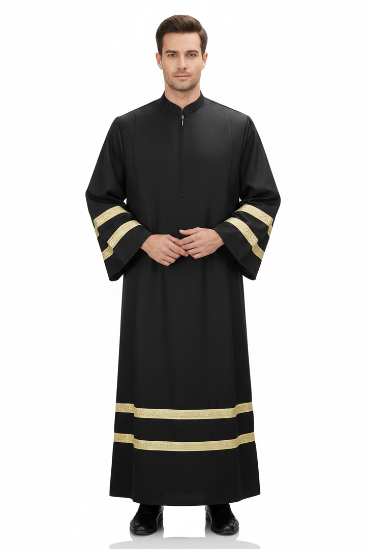 Male model wearing black liturgical choir robe with gold braid trim, full body front view, white background