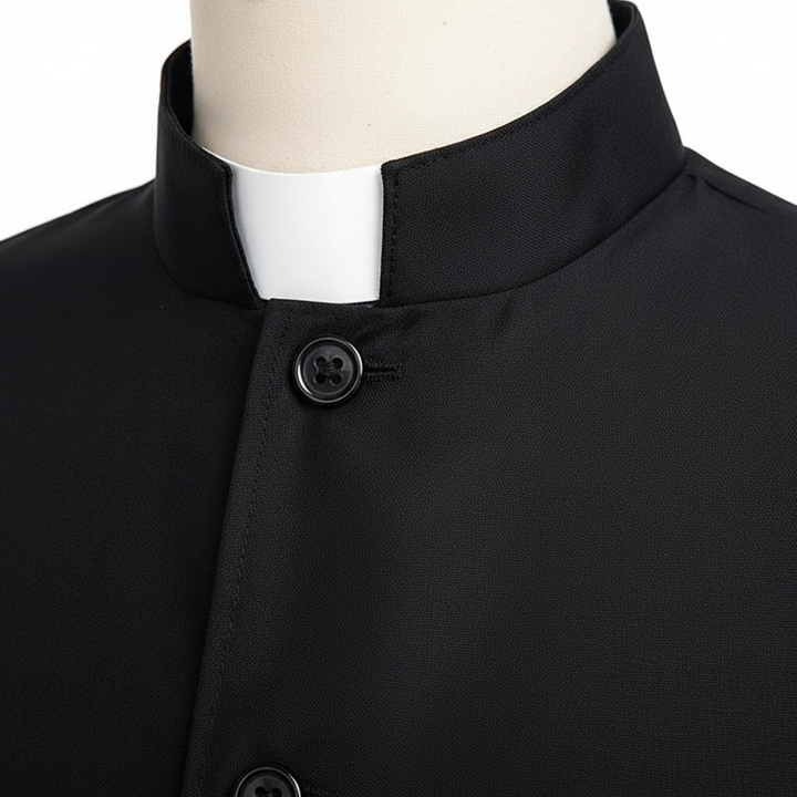 Close-up detail of black cassock robe showing stand collar with white clerical insert and front button closure, white background