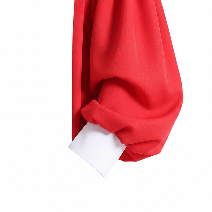 Close-up detail of red choir robe bishop puff sleeve with white cuff trim band at wrist, white background