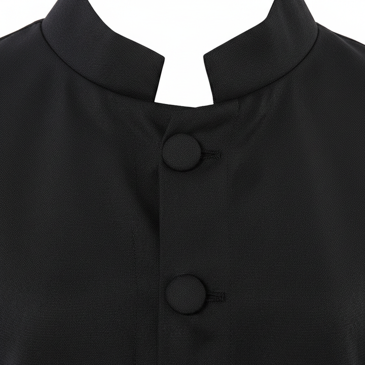Close-up detail of black cassock robe showing stand collar neckline and round black button row, white background