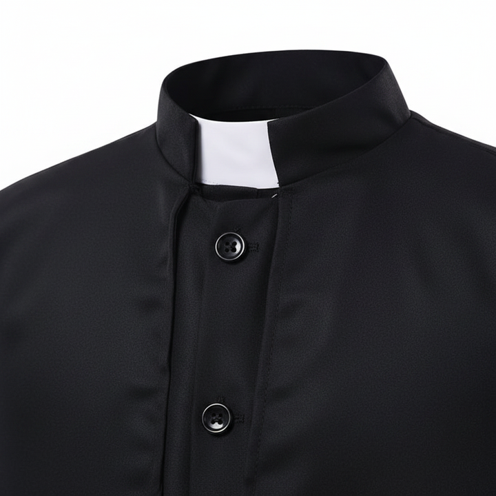 Close-up detail of black priest cassock showing cape collar and white clerical collar insert, white background