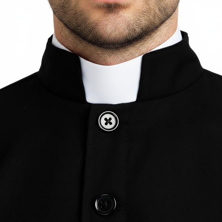 Close-up detail of black cassock robe collar showing white clerical collar insert and front button closure, white background