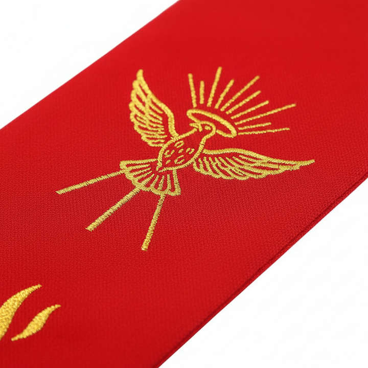 Close-up detail of red clergy stole top panel showing gold Holy Spirit dove embroidery with radiating rays, white background