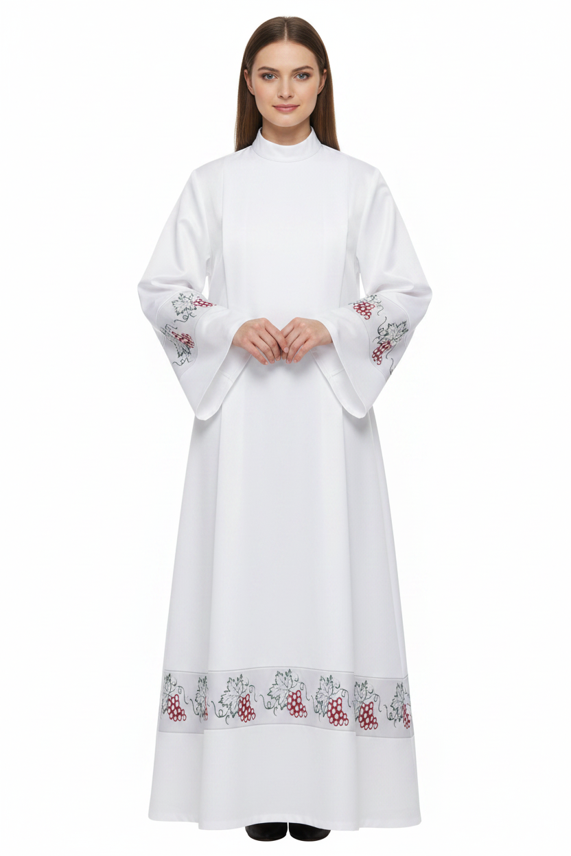 Female model wearing white clergy alb robe with grape vine embroidery cuffs and hem, full body front view, white background