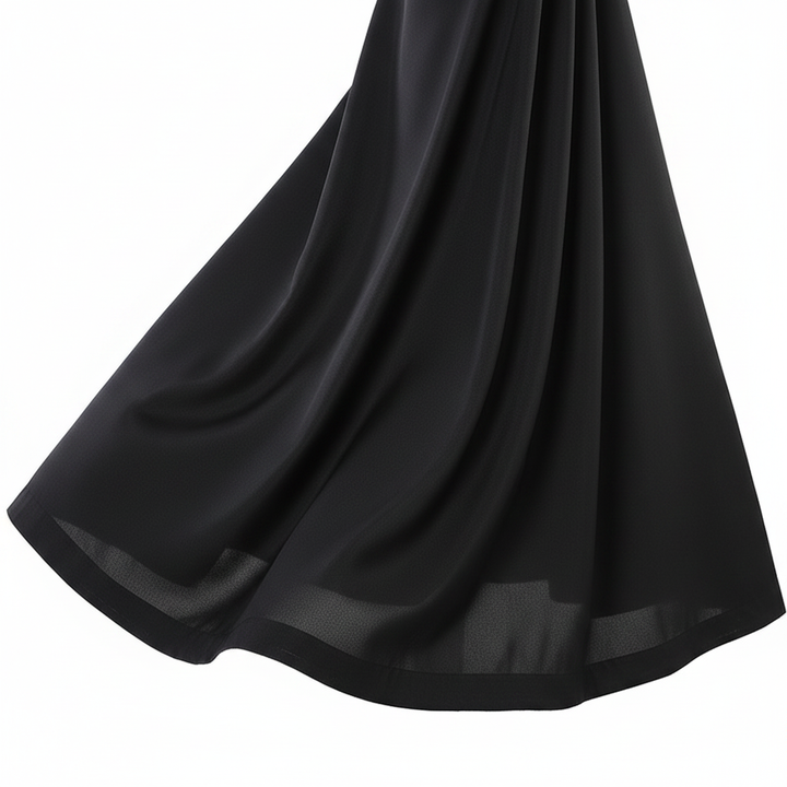 Close-up detail of black cassock robe showing A-line skirt hem flare and fabric drape from the side, white background