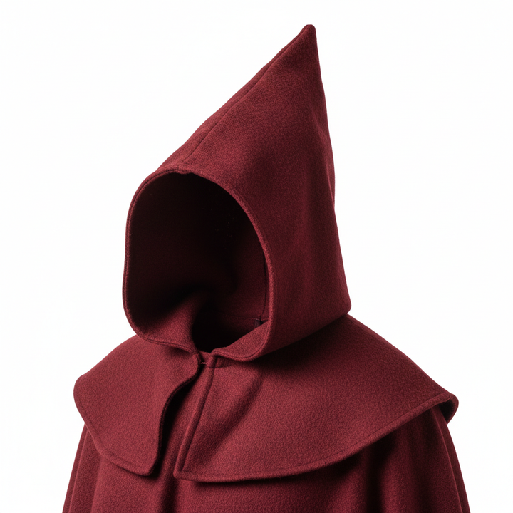 Close-up detail of medieval monk robe showing dramatic pointed hood tip and double-layer shoulder cape drape, white background