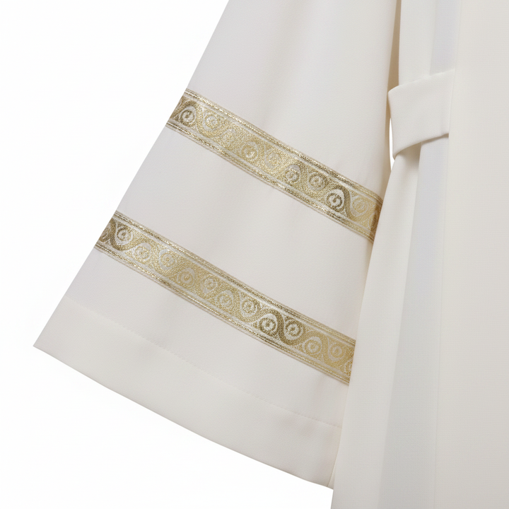 Close-up detail of ivory clergy alb robe sleeve cuff showing double horizontal gold brocade stripe trim bands, white background