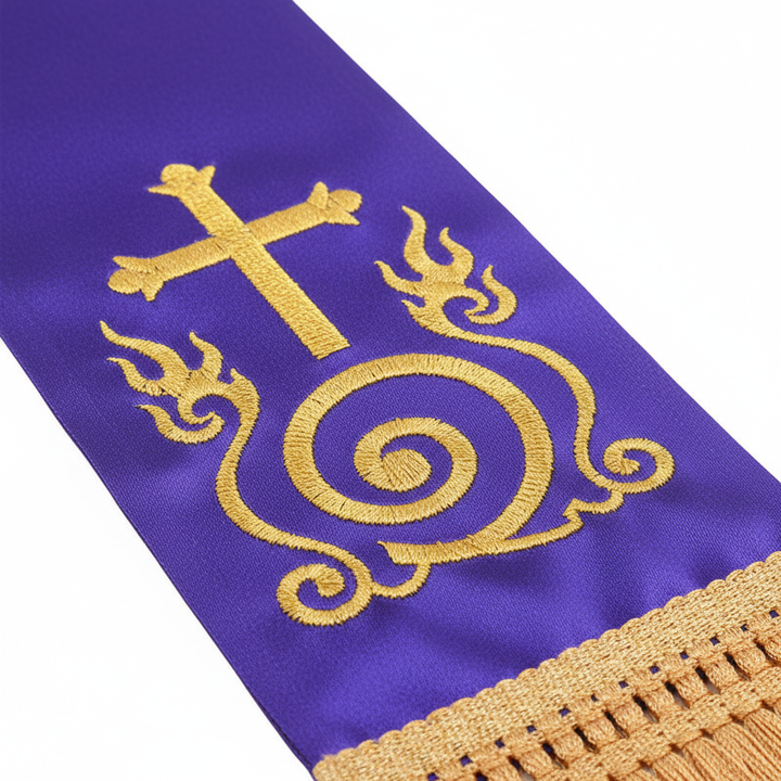 Close-up detail of purple satin clergy stole showing gold cross and flame scroll embroidery with gold fringe tassel, white background