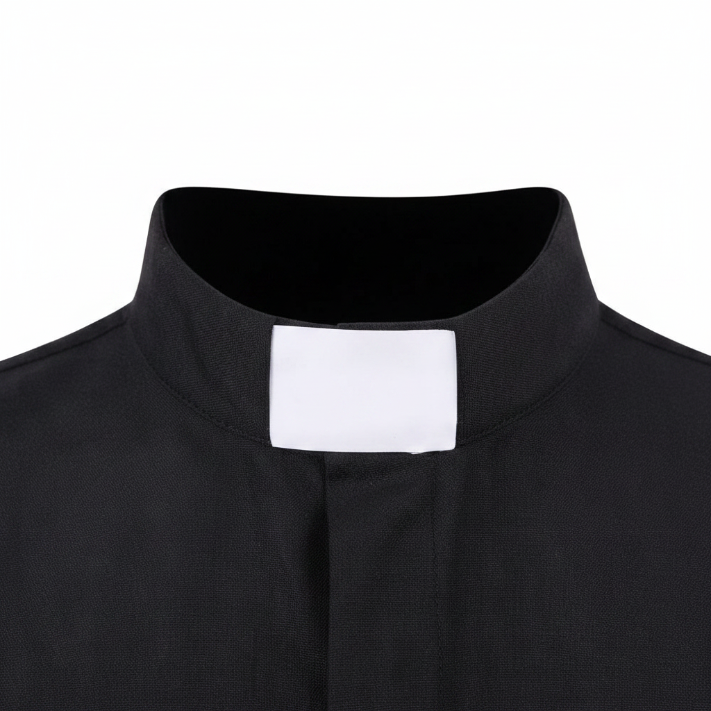 Close-up detail of white tab collar insert on black clergy shirt