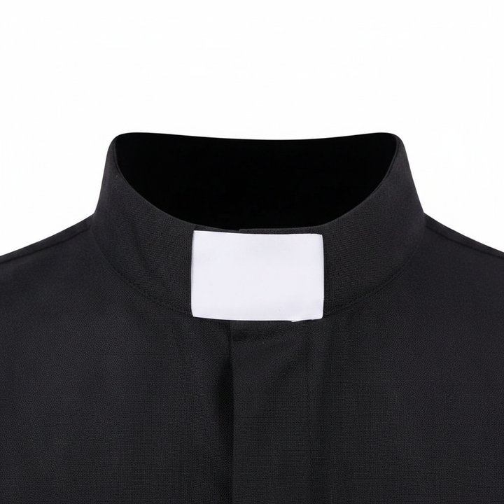 Close-up detail of white tab collar insert on black clergy shirt