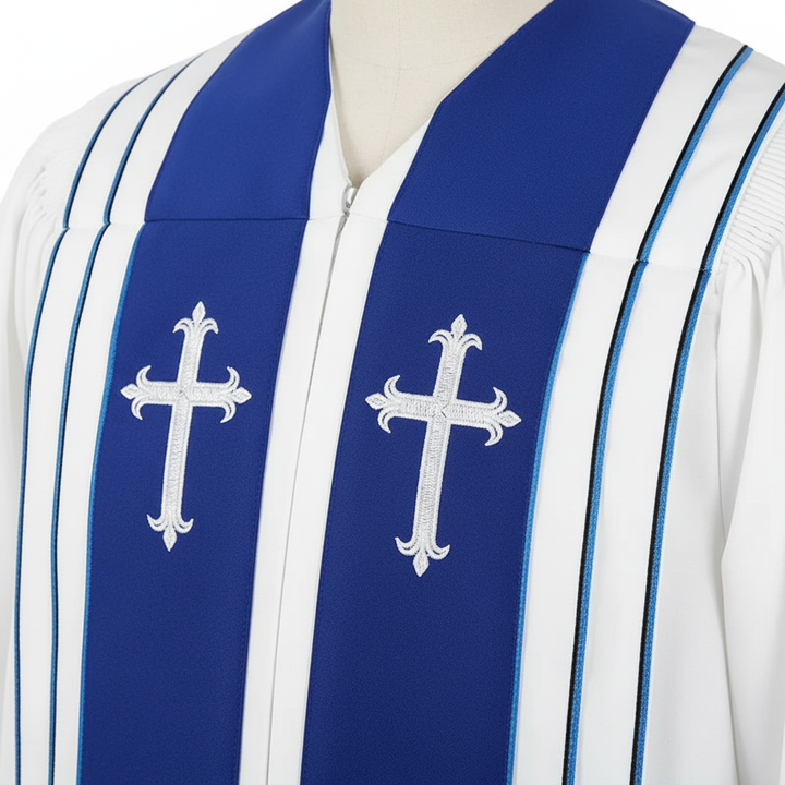 Close-up detail of white choir robe chest showing dual white cross embroidery badges on royal blue center stripe with black pinstripe borders, white background