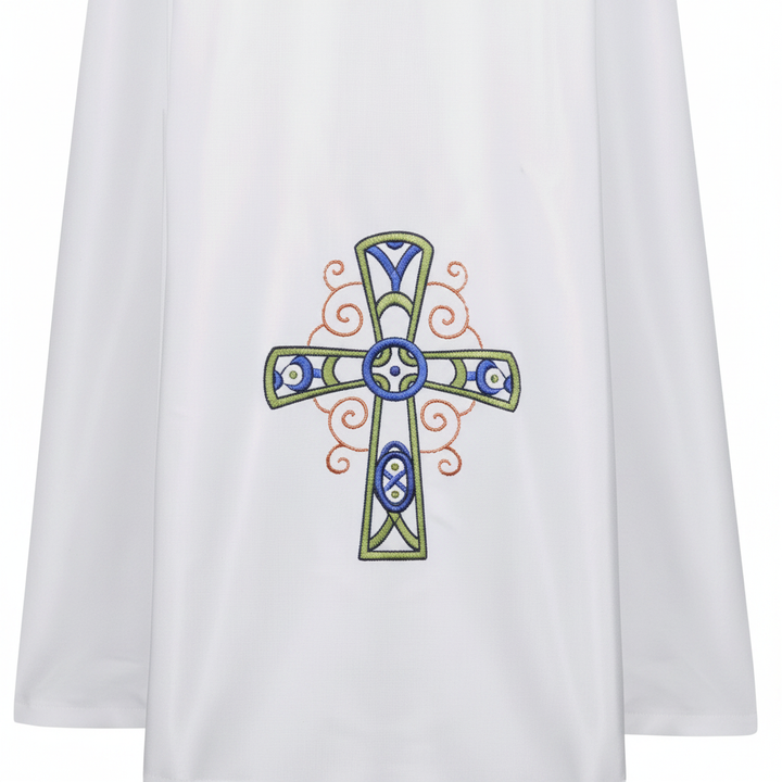 Close-up detail of Style E alb robe showing colorful Celtic cross embroidery in blue green gold at lower hem, white background